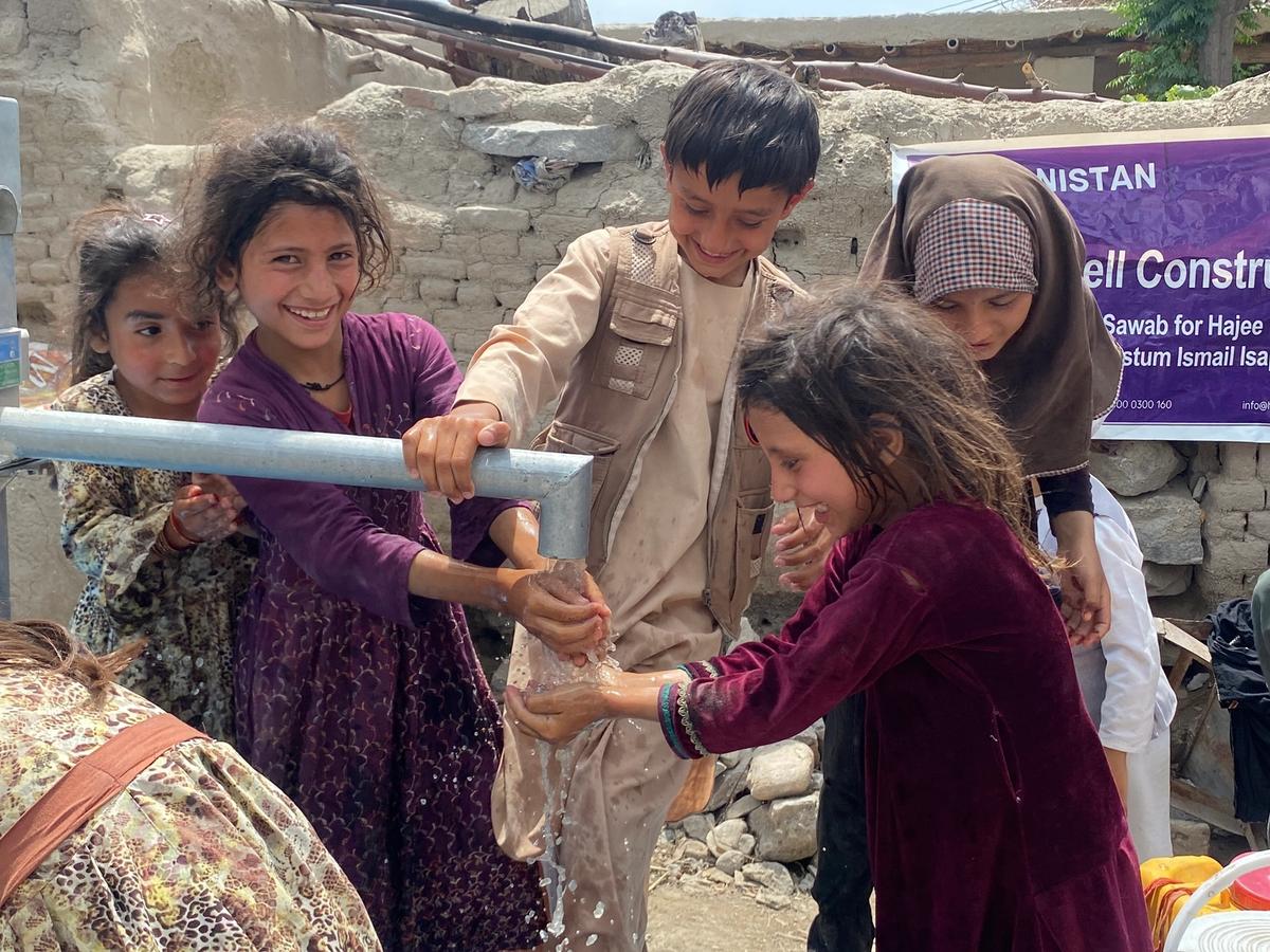 Children in Afghanistan happy to drink water from a water well | Human Relief Mission