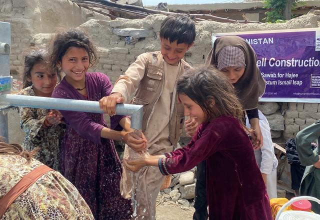 Children in Afghanistan enjoying water from water well | Human Relief Mission