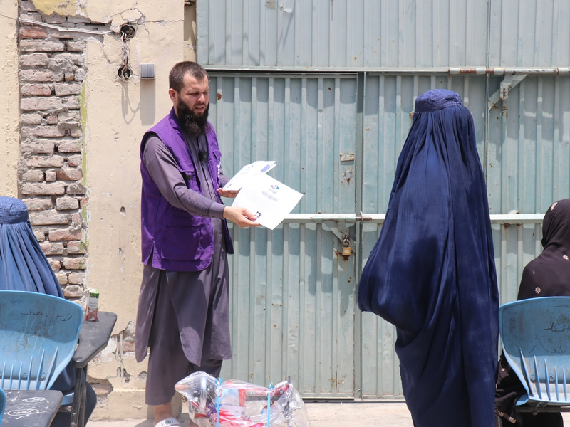 Mariam receiving her Sewing course certificate