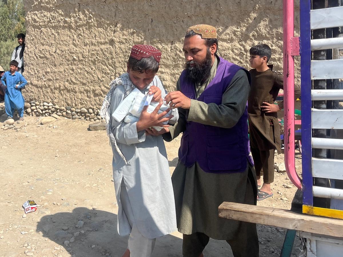 An Afghan child receiving a hygiene kit | Human Relief Mission