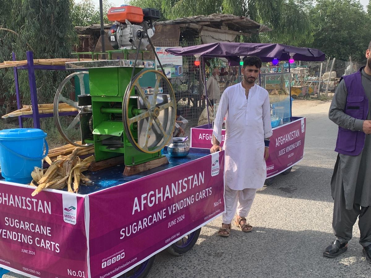 Afghan man with his Fresh Juice cart (IGP) with Human Relief Mission aid worker
