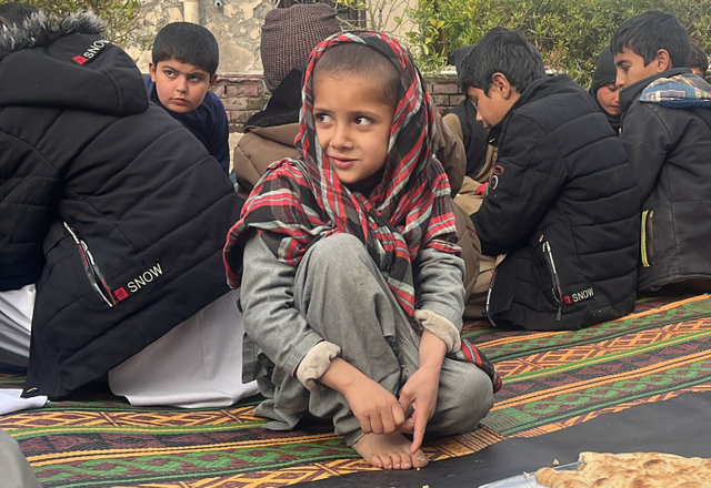 Child eating on the floor in Afghanistan