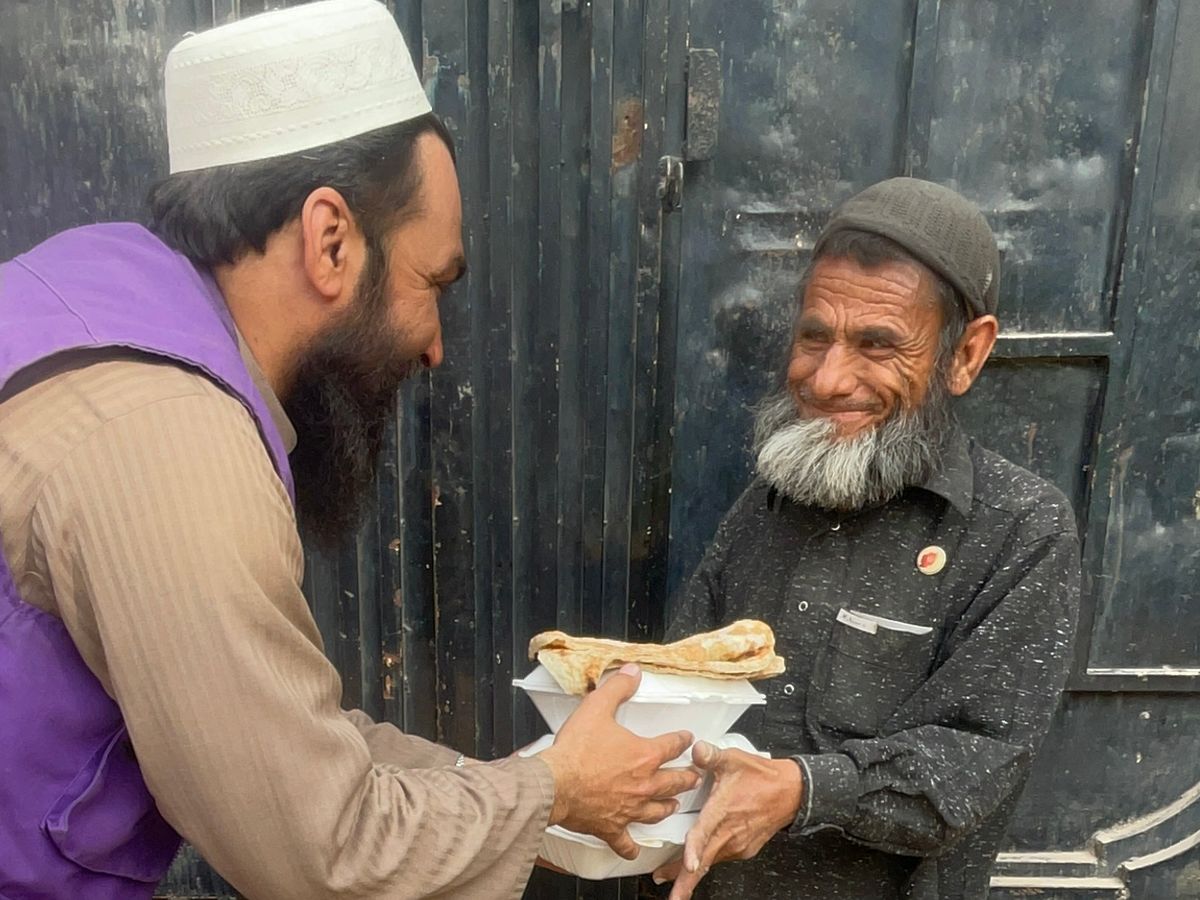 Man in Afghanistan receiving a hot meal | Human Relief Mission
