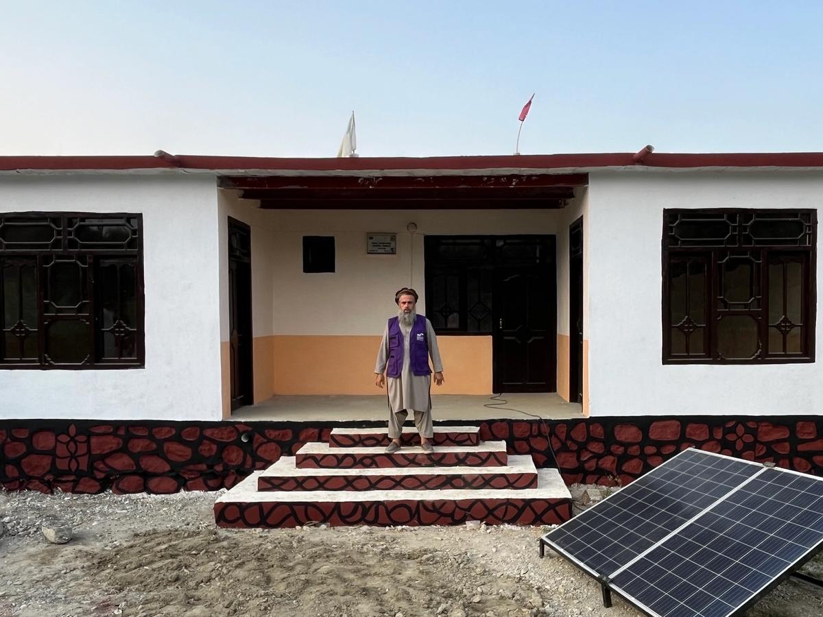A man (HRM Charity Aid worker) outside a home in Afghanistan | Human Relief Mission