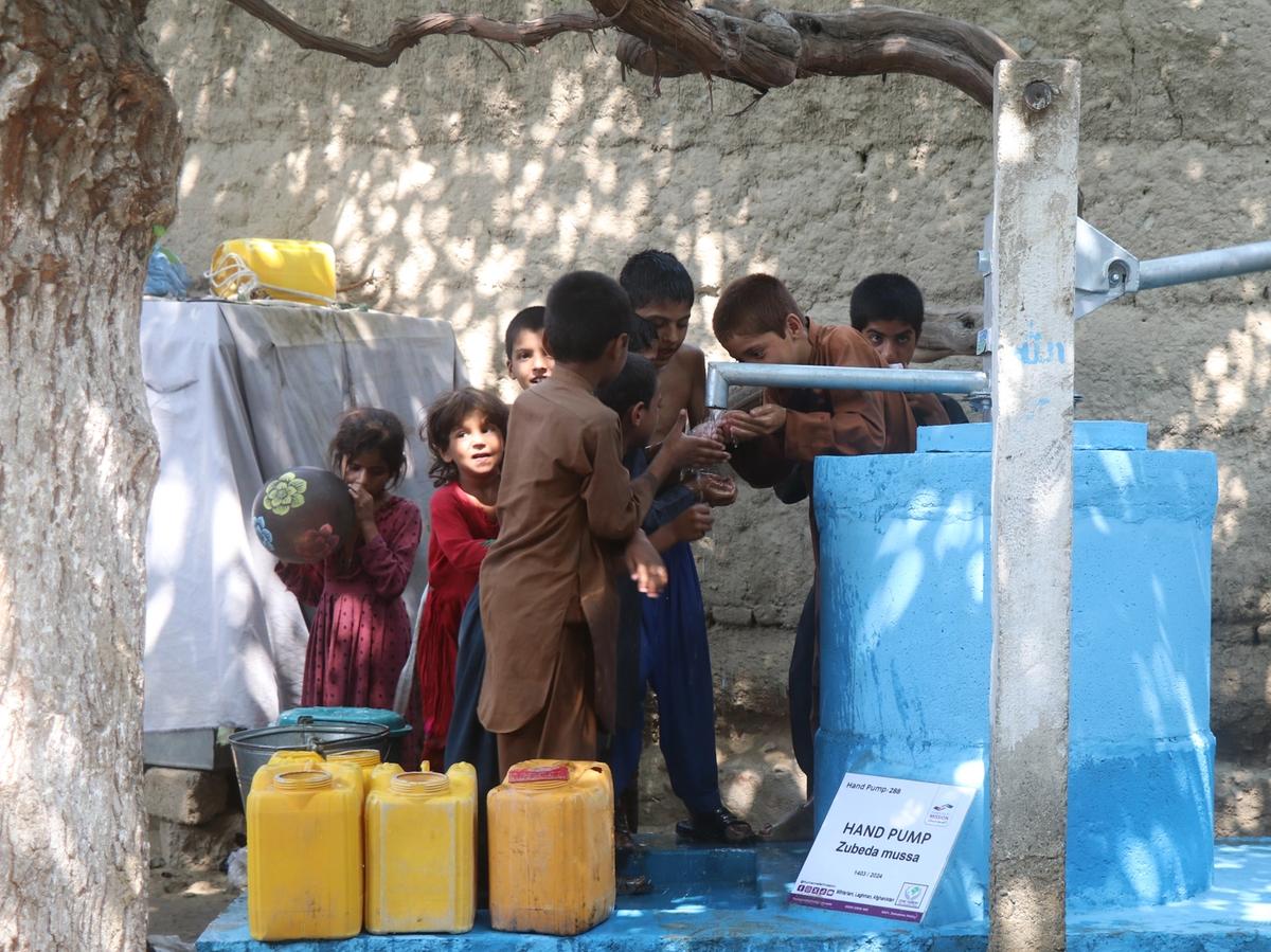 Children happy with water from a handpump in Afghanistan | Human Relief Mission