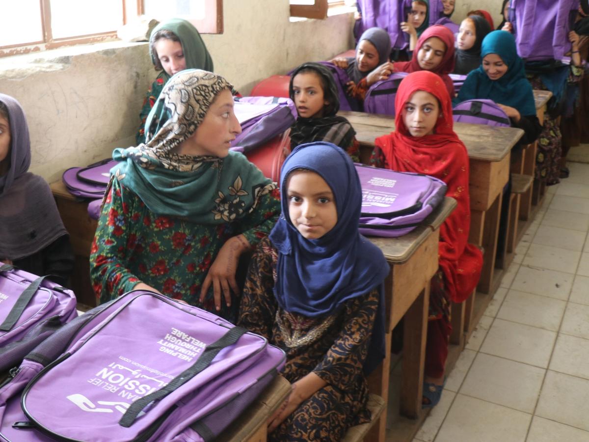 Students in Afghanistan school receiving bags with stationary and books | Human Relief Mission