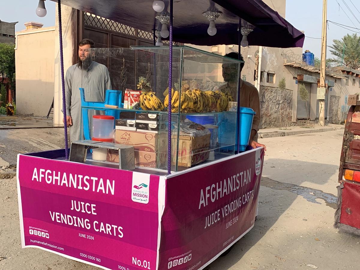 Afghan man with his Fresh Juice cart (IGP) with Human Relief Mission aid worker