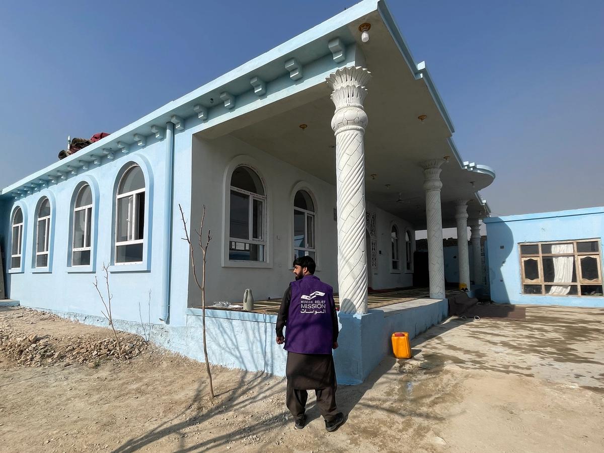 HRM Charity Aid Worker infront of a mosque in an Afghanistan Village | Human Relief Mission