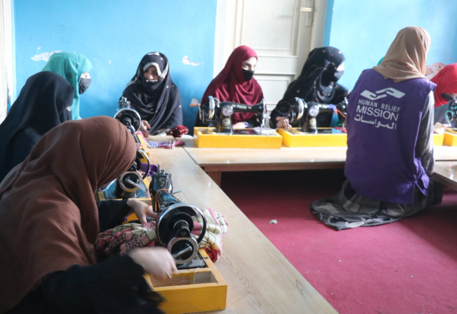 Women in Afghanistan with Sewing Machine with HRM Charity Aid Worker | Human Relief Mission