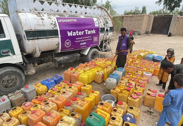 Buckets being filled up from a water tanker by HRM Aid Worker in Afghanistan | Human Relief Mission
