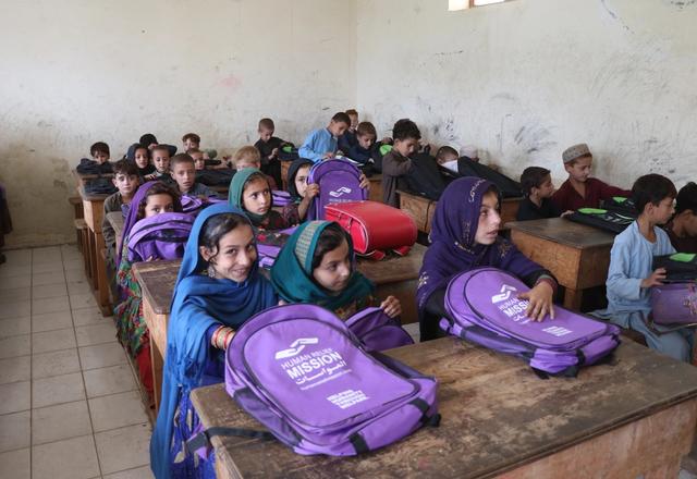 Students in Afghanistan Receiving a Bag with Stationary