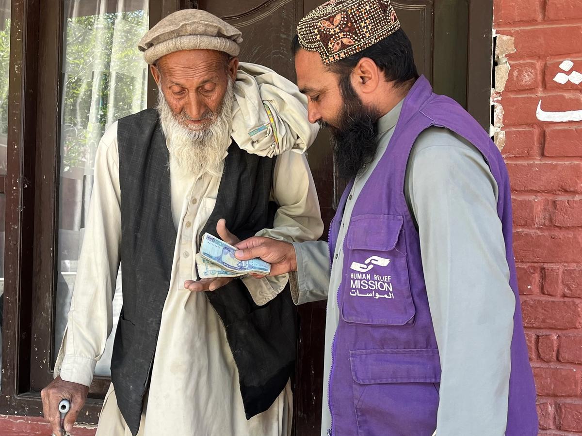 An old man in Afghanistan Receiving Cash | Human Relief Mission