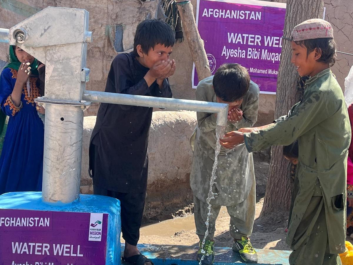 Children in Afghanistan drinking water from a water well | Human Relief Mission