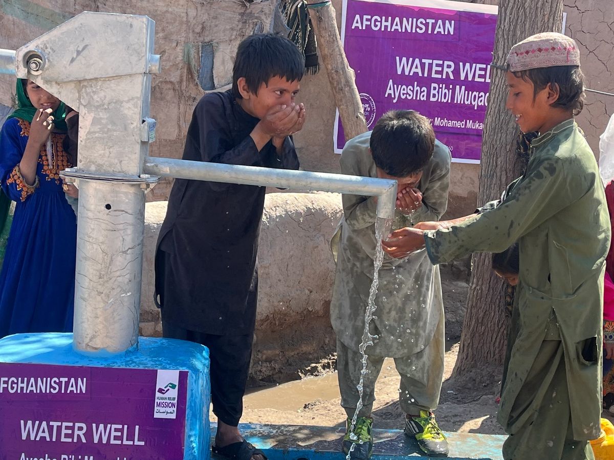 Children in Afghanistan drinking water from a water well | Human Relief Mission