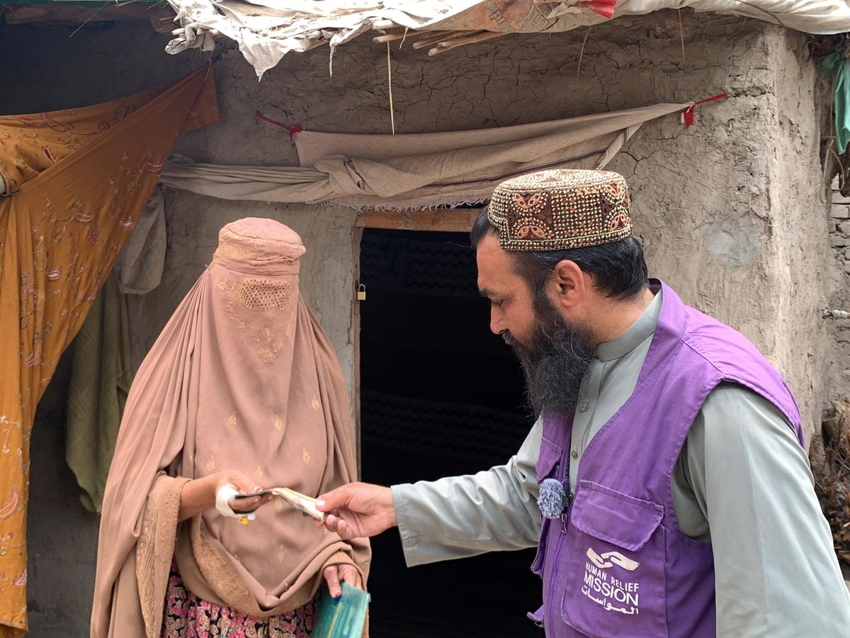 A Woman in Afghanistan Receiving Cash | Human Relief Mission