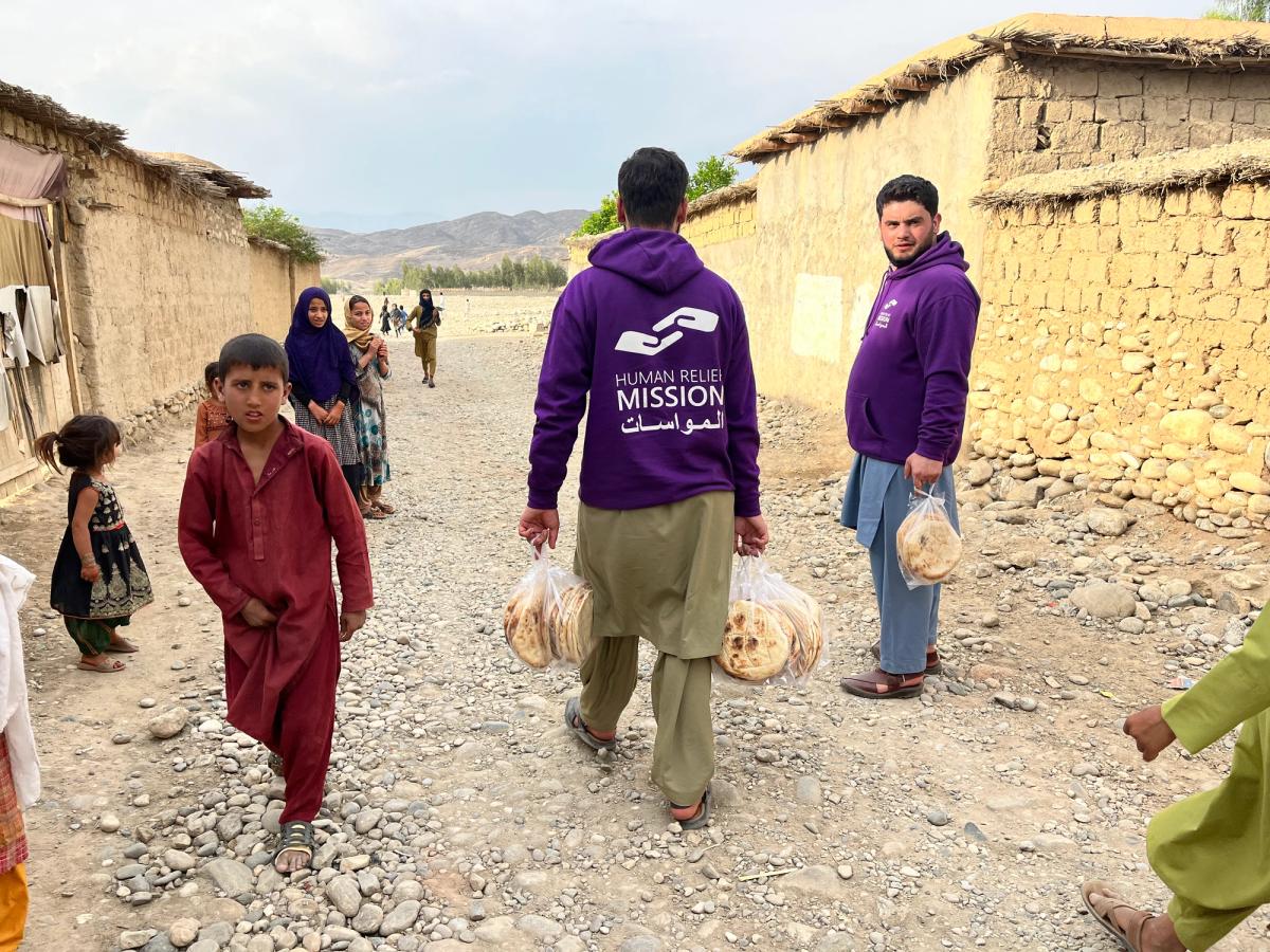 HRM aid workers distributing fresh bread
