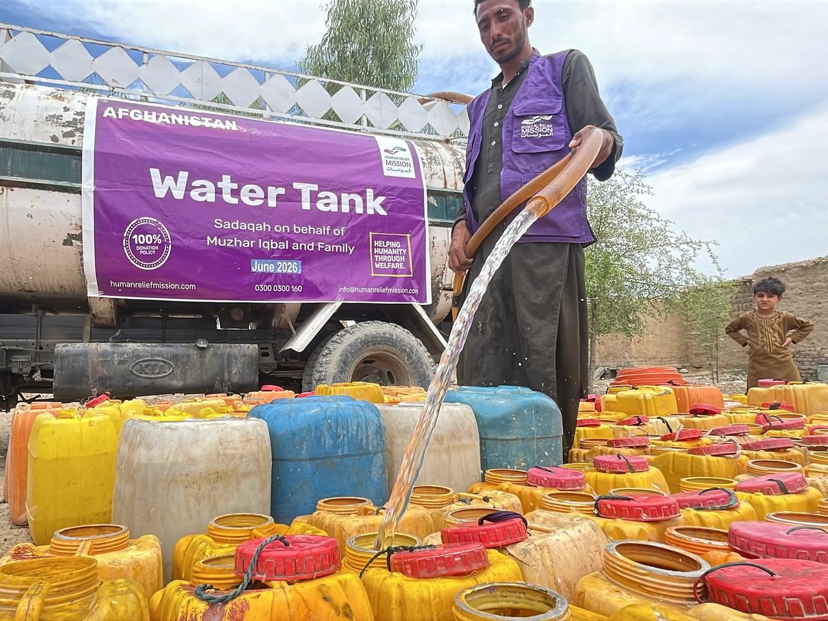 Man in Afghanistan pouring water into buckets from a Water tanker | Human Relief Mission