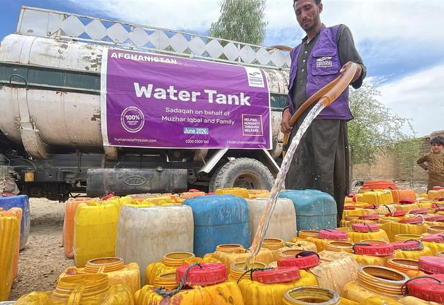 Close up of Buckets being filled up from a water tanker by HRM Aid Worker in Afghanistan | Human Relief Mission