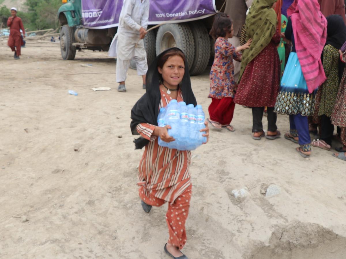 Girl in Afghanistan with water bottles case | Human Relief Mission