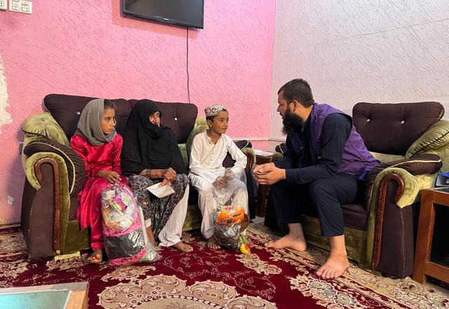 HRM Charity aid Worker with a family in Afghanistan | Human Relief Mission