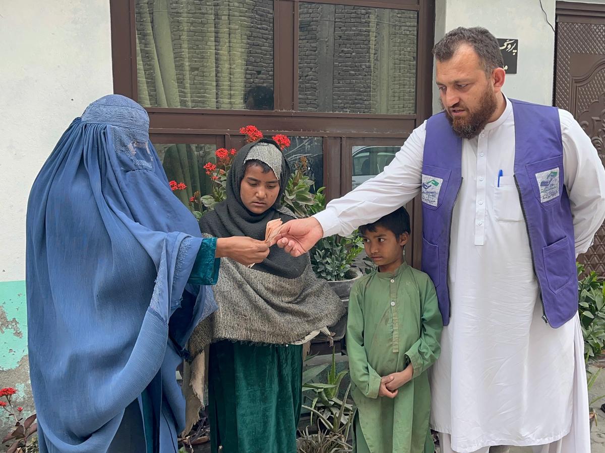 HRM Charity Aid Worker giving cash to Widow and her family | Human Relief Mission