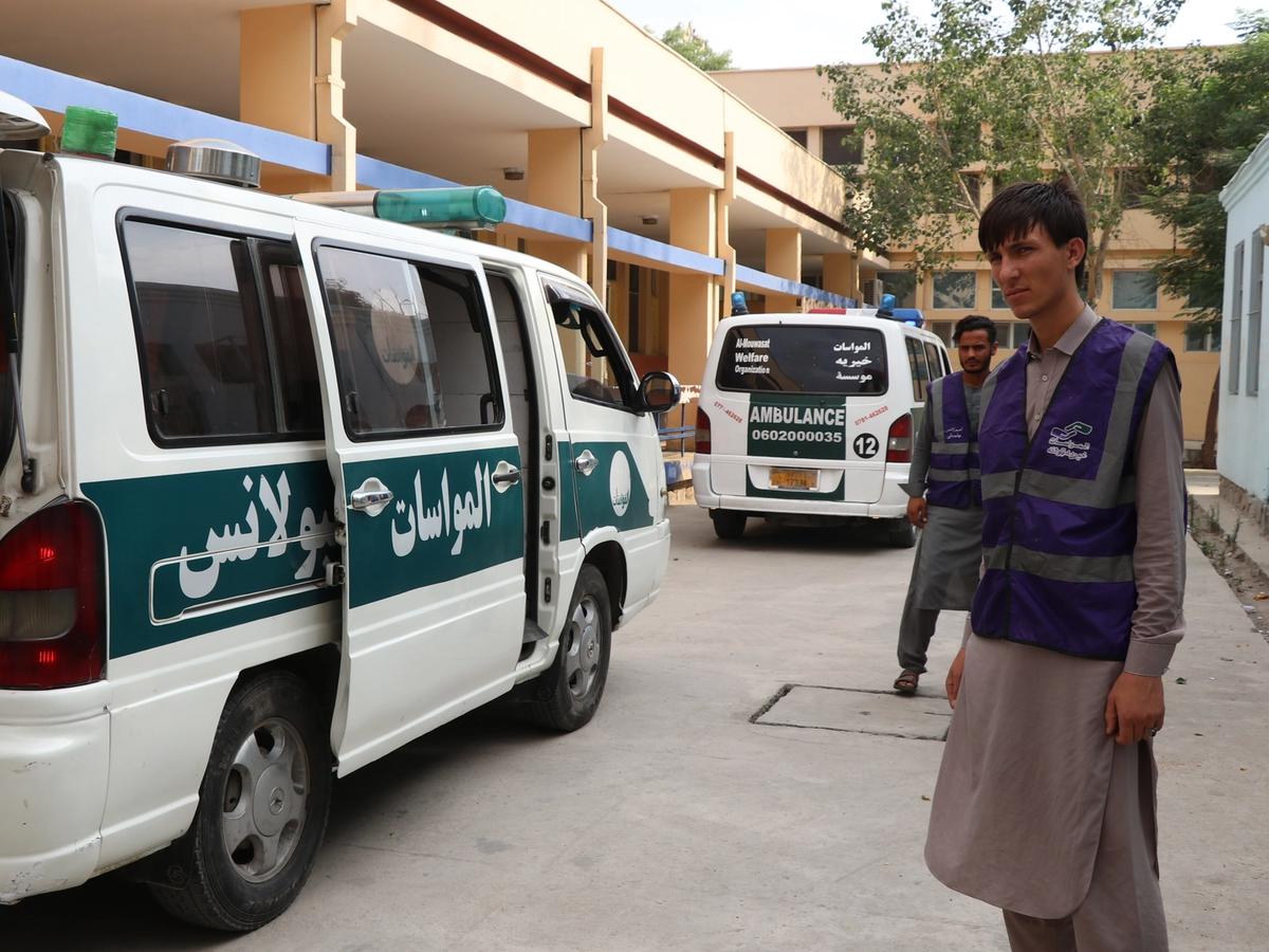HRM Aid Worker Next to Ambulance | Human Relief Mission 