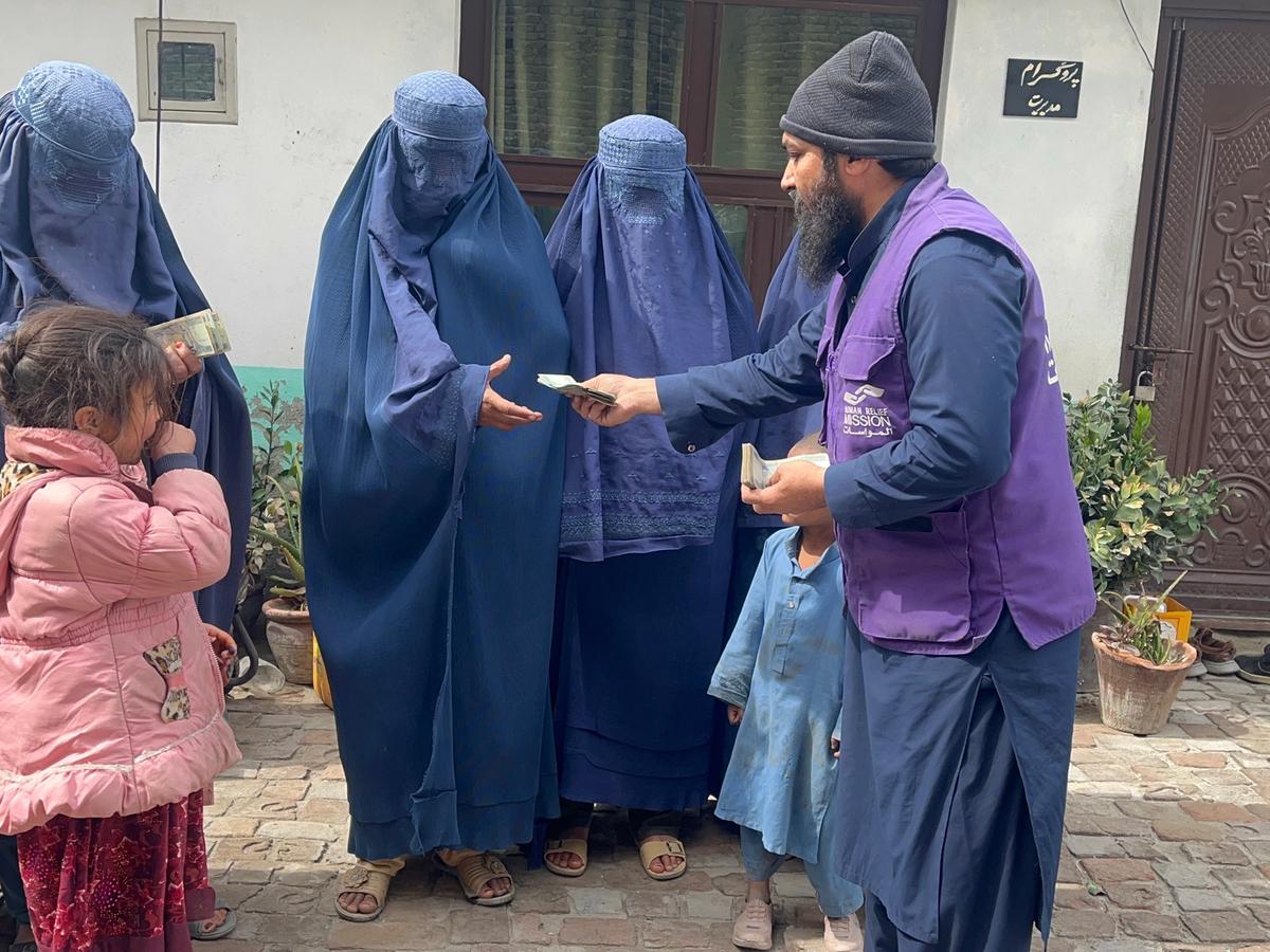 HRM Charity Aid Worker giving cash to widows in Afghanistan | Human Relief Mission