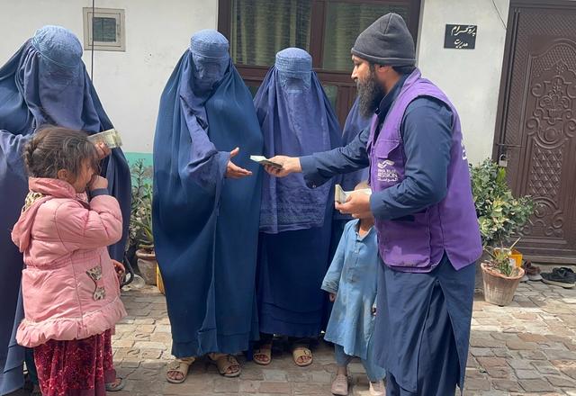 Widows Receiving Cash assistance from HRM Charity Aid Worker | Human Relief Mission