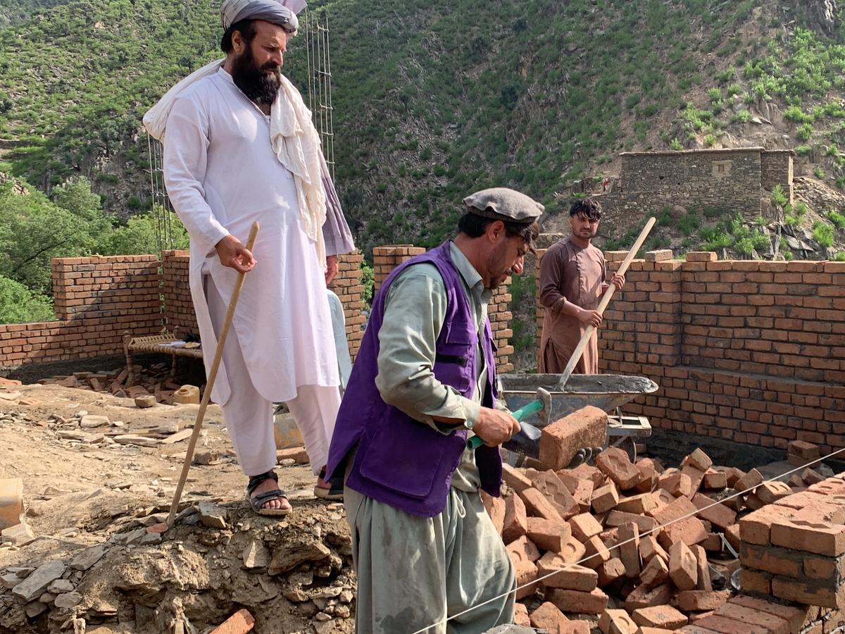 Locals in Afghanistan and HRM Charity Aid Worker constructing a masjid | Human Relief Mission