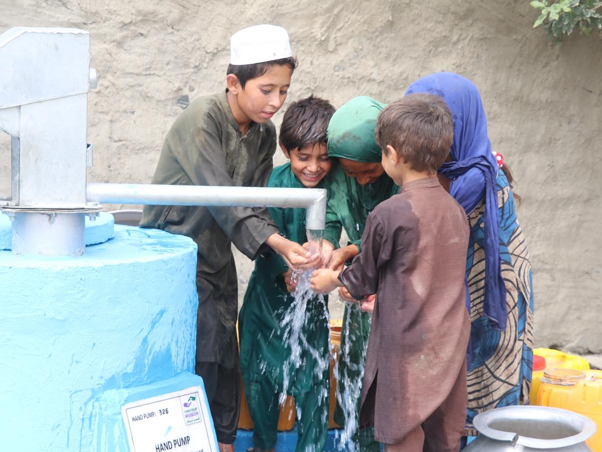 Children getting water from a handpump in Afghanistan | Human Relief Mission