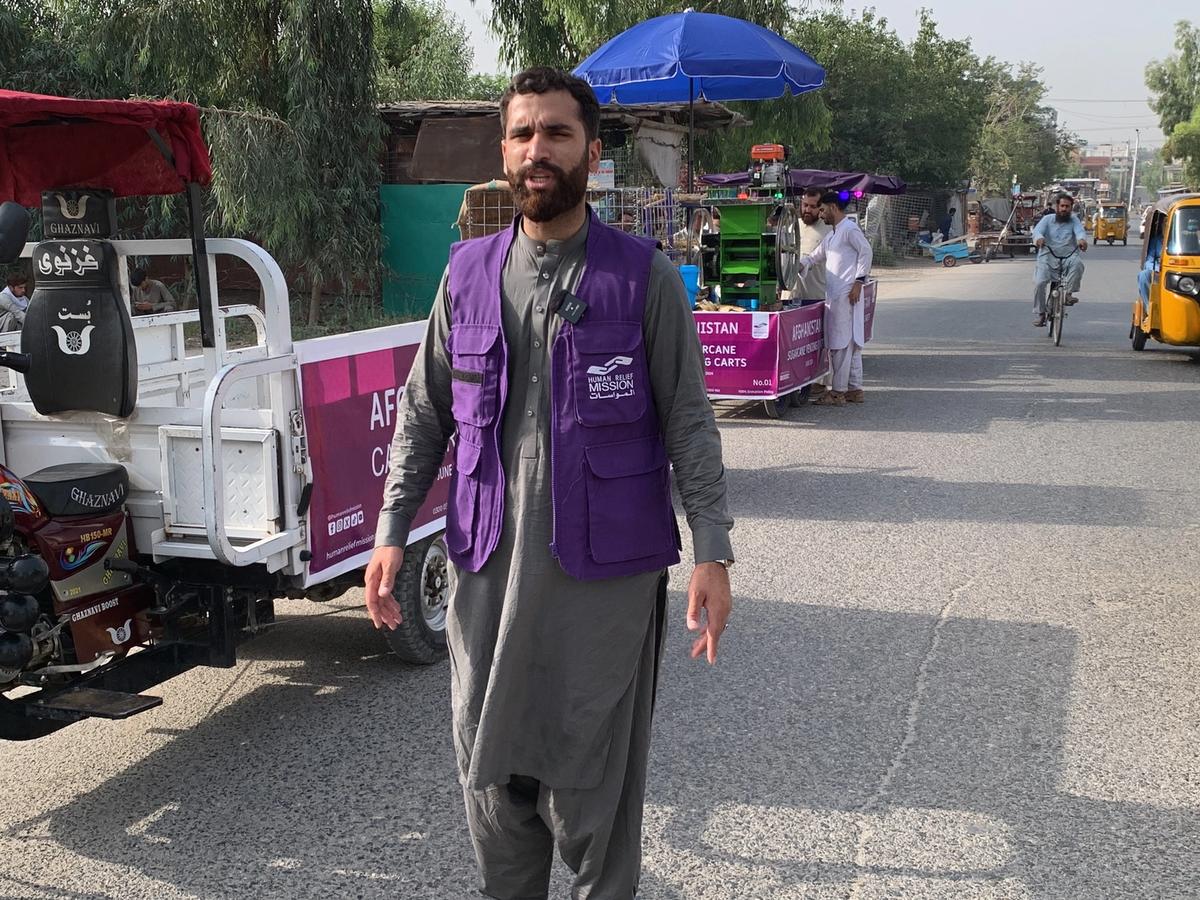 HRM Aid Worker Next to Cargo Tricycle in Afghanistan | Human Relief Mission