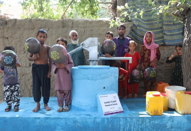 Children and families getting water from a Handpump in Afghanistan | Human Relief Mission