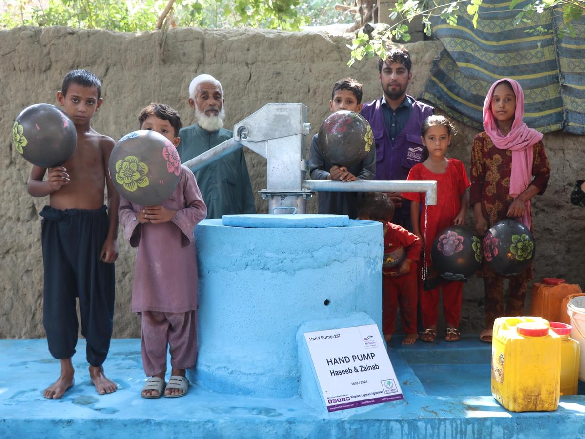 Families with a handpump in Afghanistan | Human Relief Mission