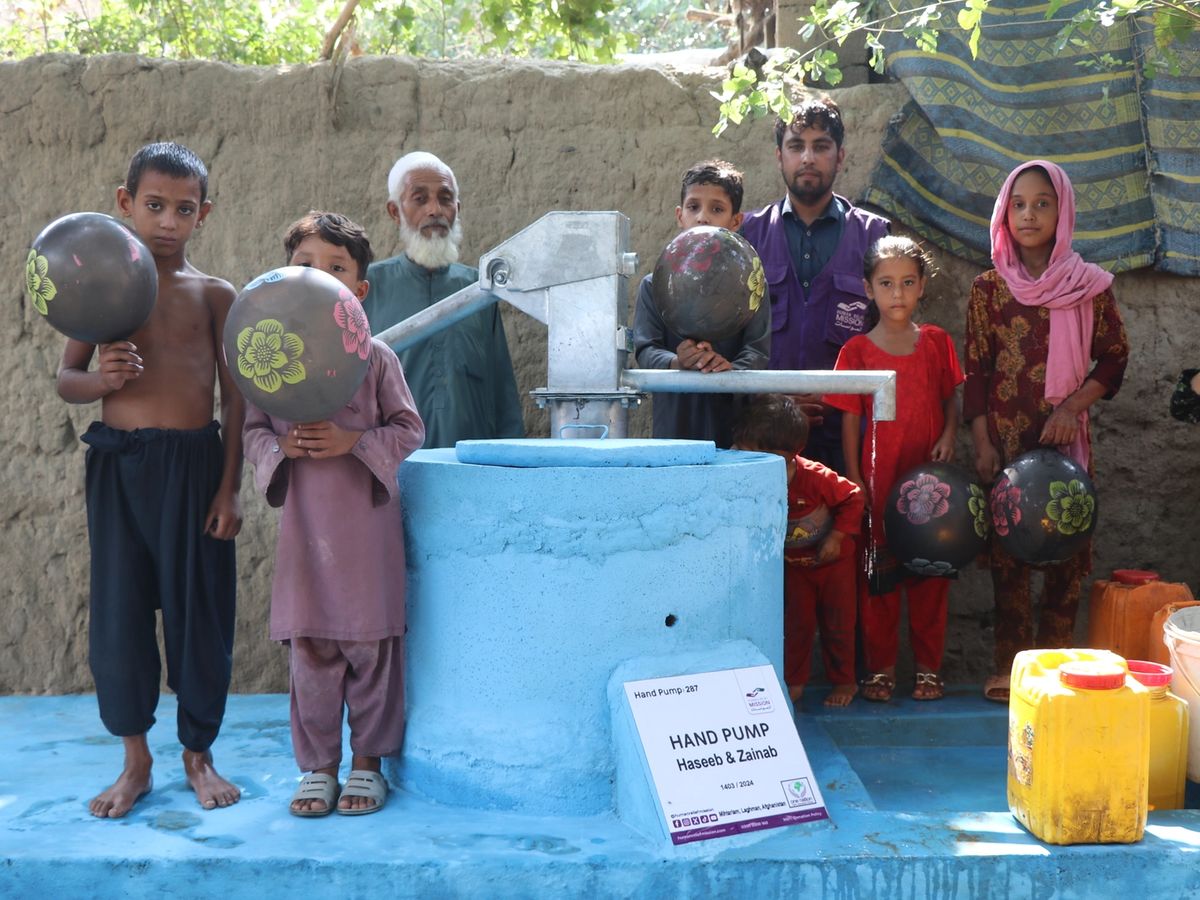 Families with a handpump in Afghanistan | Human Relief Mission