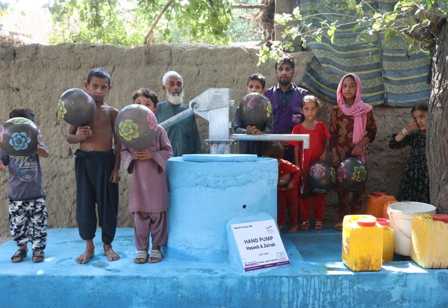 Children and families getting water from a Handpump in Afghanistan | Human Relief Mission