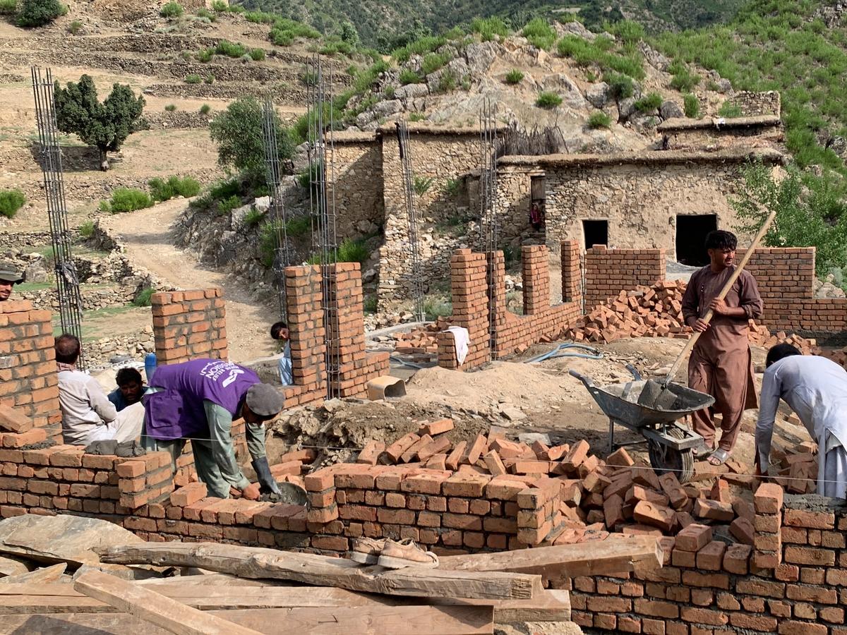 Locals in Afghanistan and HRM Charity Aid Workers helping to construct a masjid | Human Relief Mission