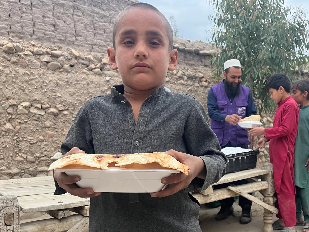 Child in Afghanistan with a hot meal | Human Relief Mission