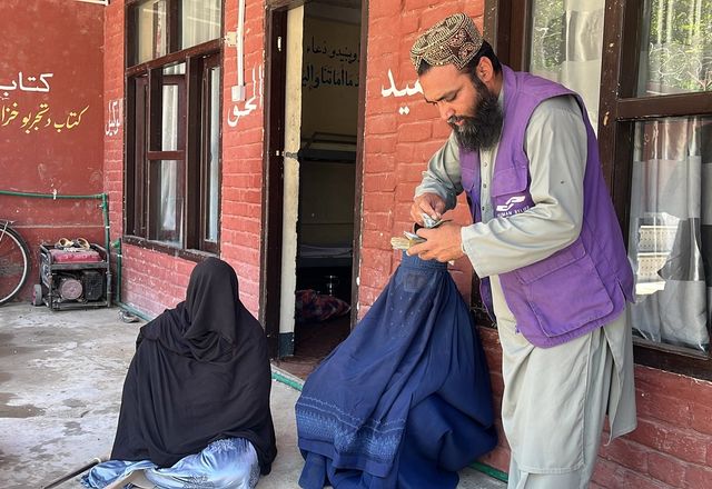 HRM Charity Aid Worker with Widows in Afghanistan receiving Cash | Human Relief Mission