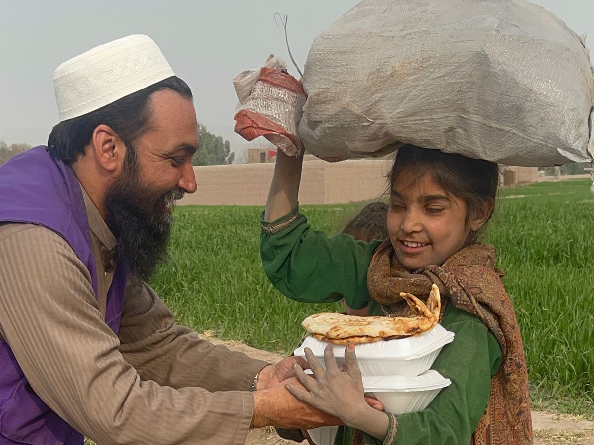 Child in Afghanistan receiving a hot meal | Human Relief Mission