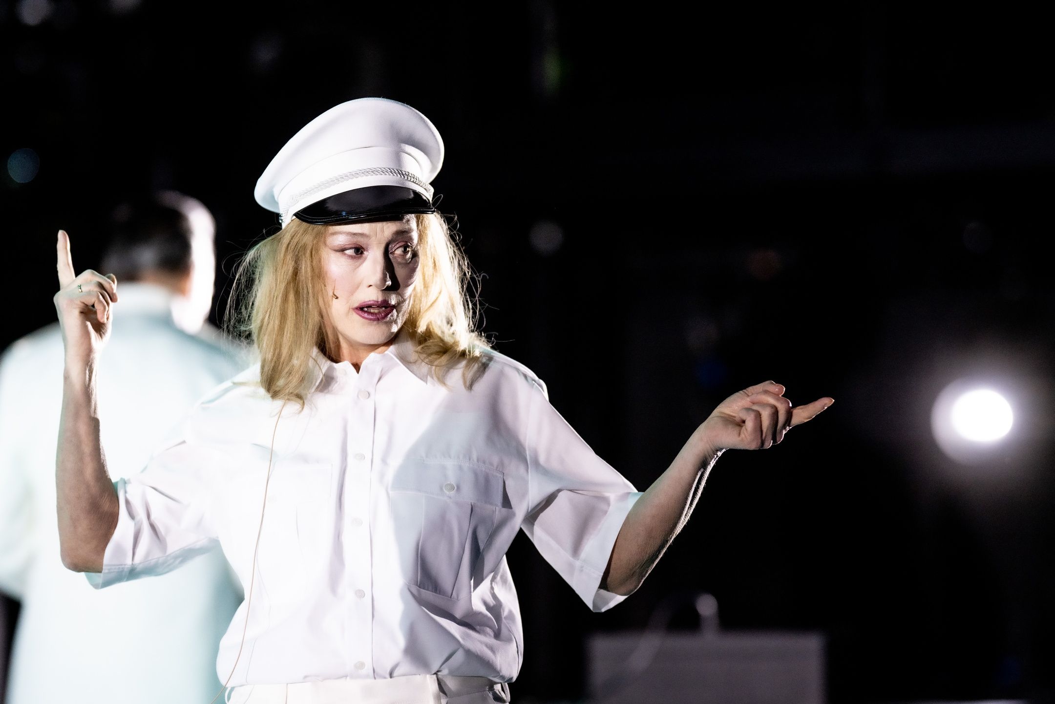 Kvinne i lys uniform som gestikulerer