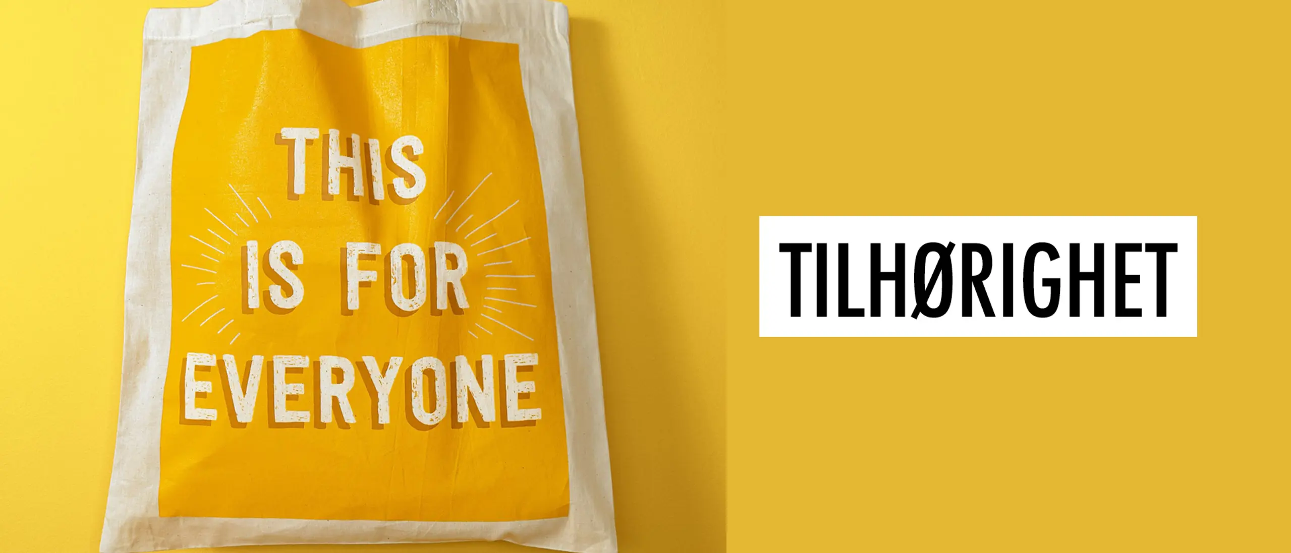 En totebag med påskrift "This is for everyone" på gul bakgrunn, og teksten "Tilhørighet"