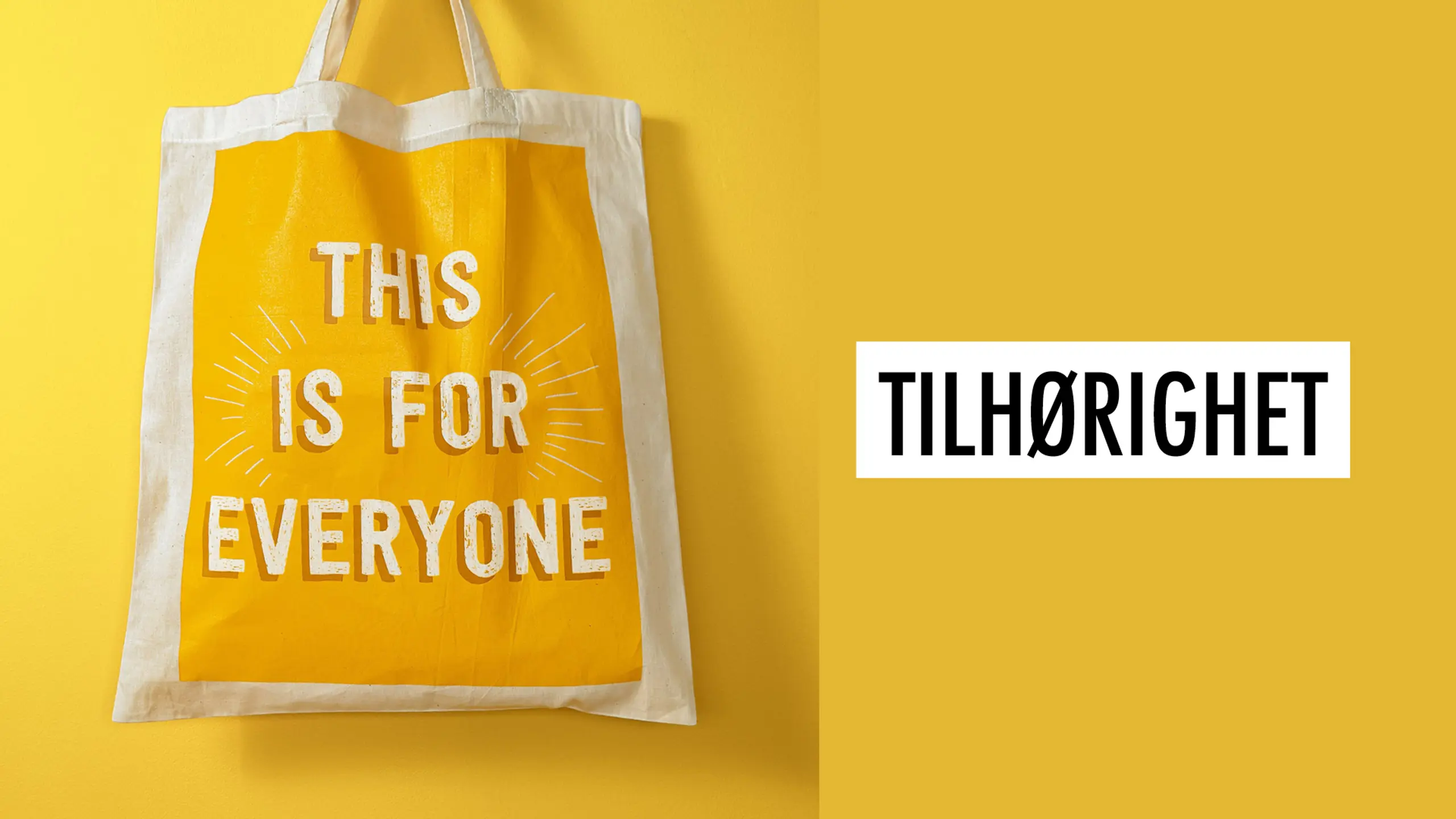 En totebag med påskrift "This is for everyone" på gul bakgrunn, og teksten "Tilhørighet"