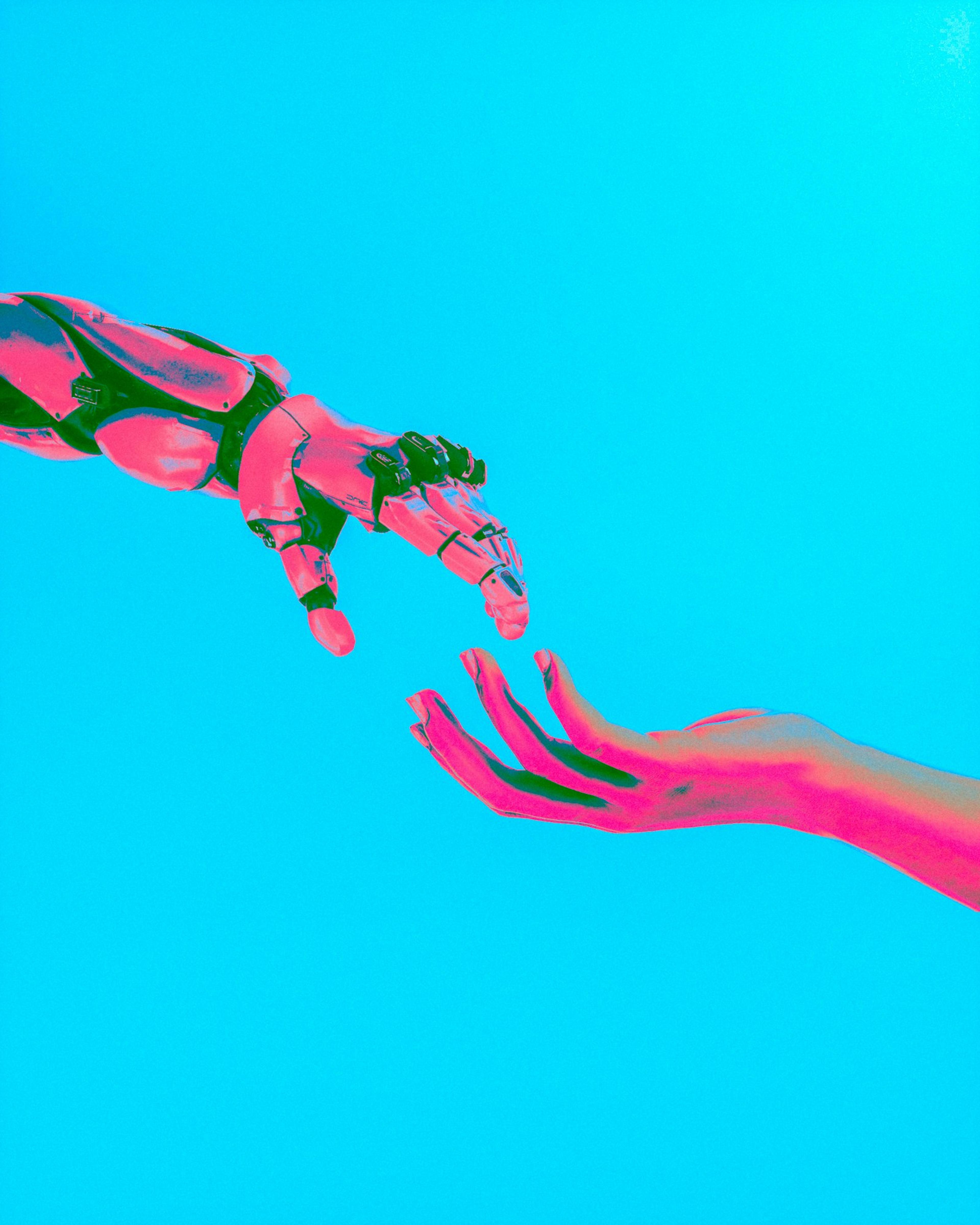 Robot and human hands reaching toward each other, representing AI in production