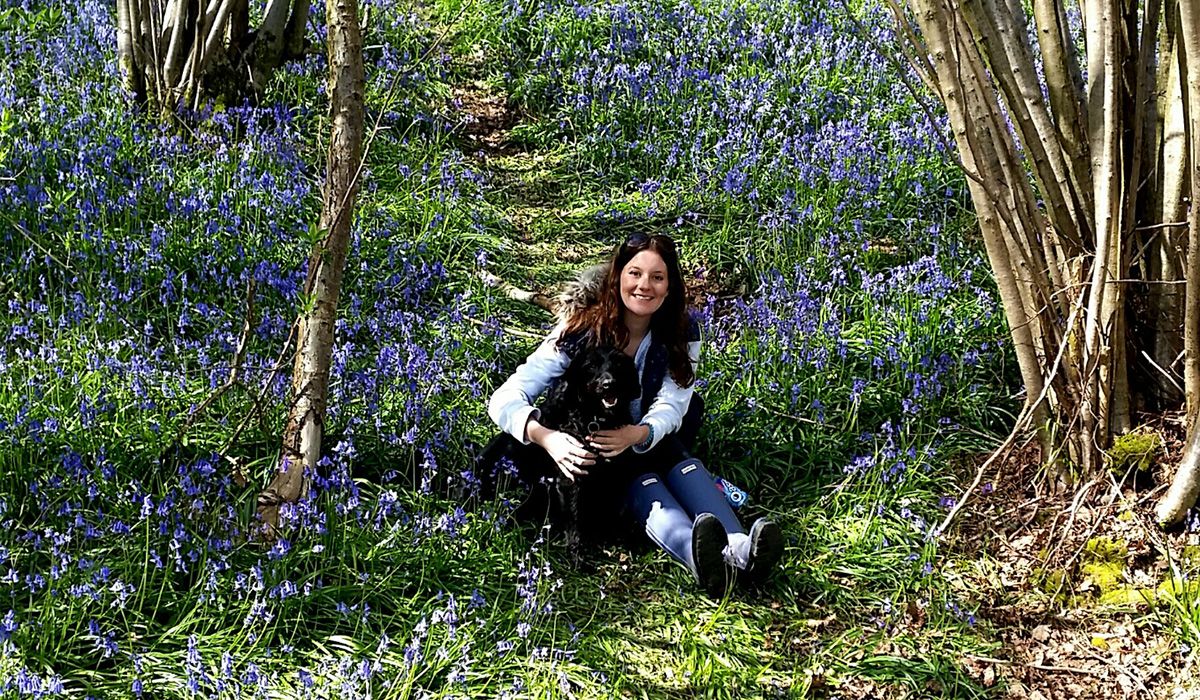 Phin and Naomi cuddle and pose in a wood full of bluebells