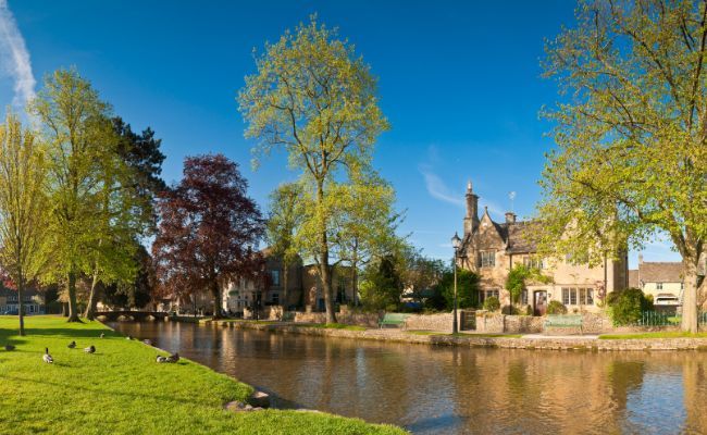 The river side at Bourton-on-Water on a quiet summer's morning