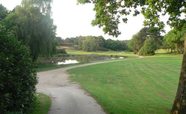 One of the winding paths next to the lake at Queens Park in Bournemouth