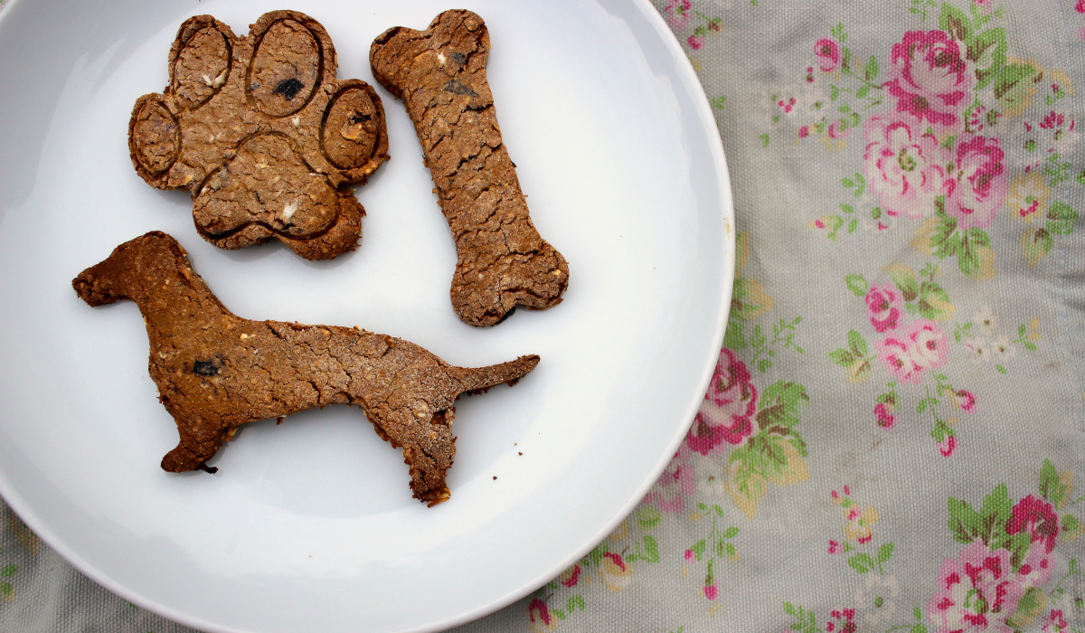 A plate of Blueberry Crunch Cookies, in the shape of a Dachshund, a bone and a paw.