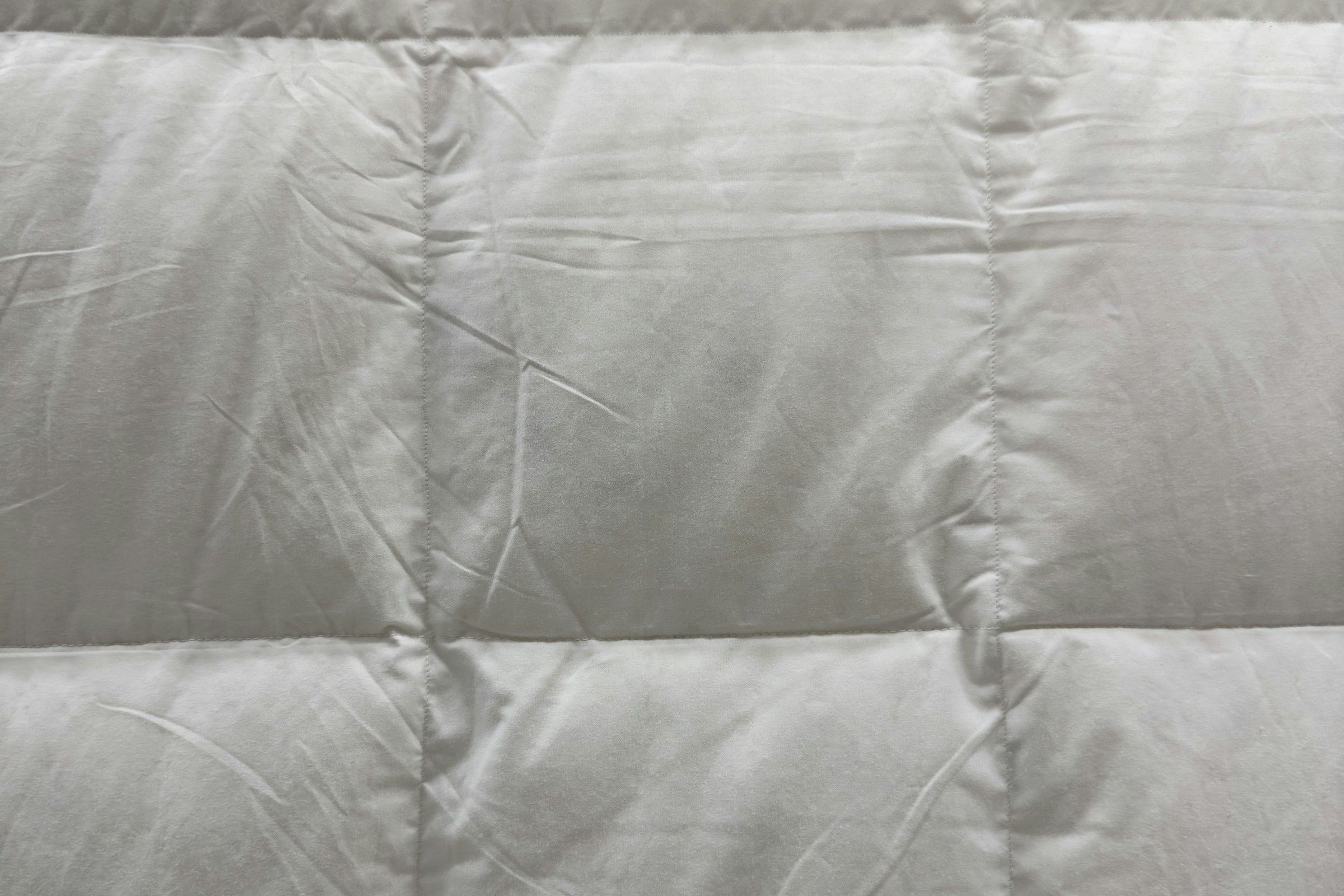 Close-up of a white quilted hotel duvet