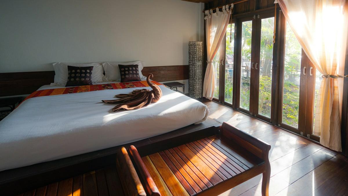 Resort suite bedroom with a bed in white linen