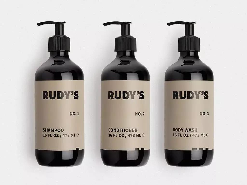 Rudy's brand bottles of shampoo, conditioner, and body wash.